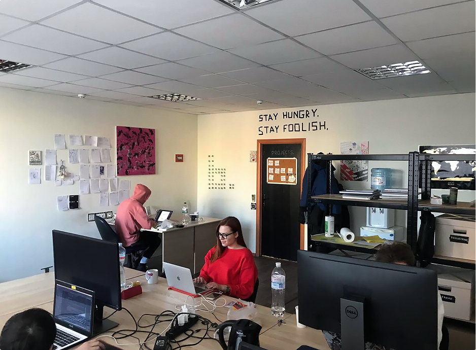 Office space with slogan on the wall - 'Stay hungry. Stay foolish'